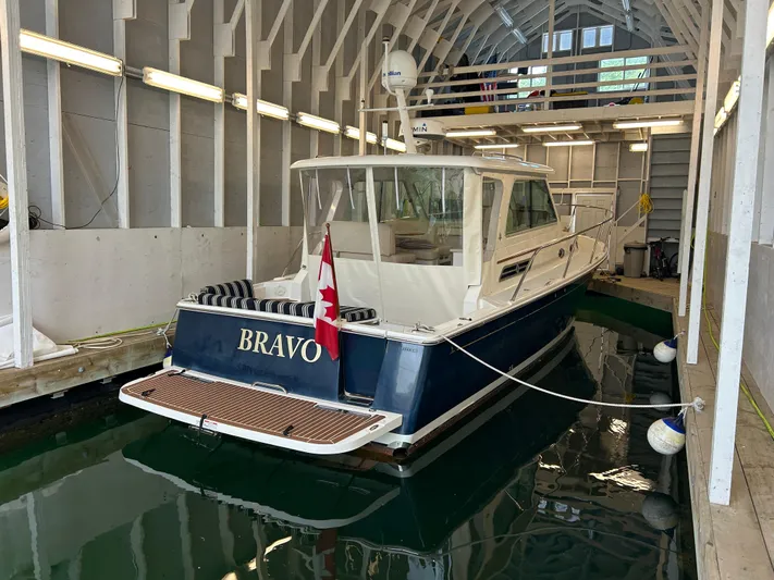  Yacht Photos Pics 2015 Back Cove 34 boat named "Bravo" docked in a covered marina.
