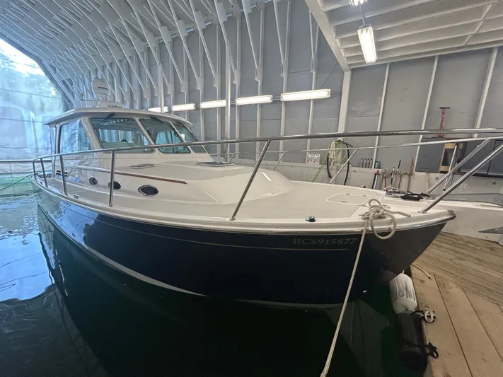  Yacht Photos Pics 2015 Back Cove 34 boat docked in a covered marina.