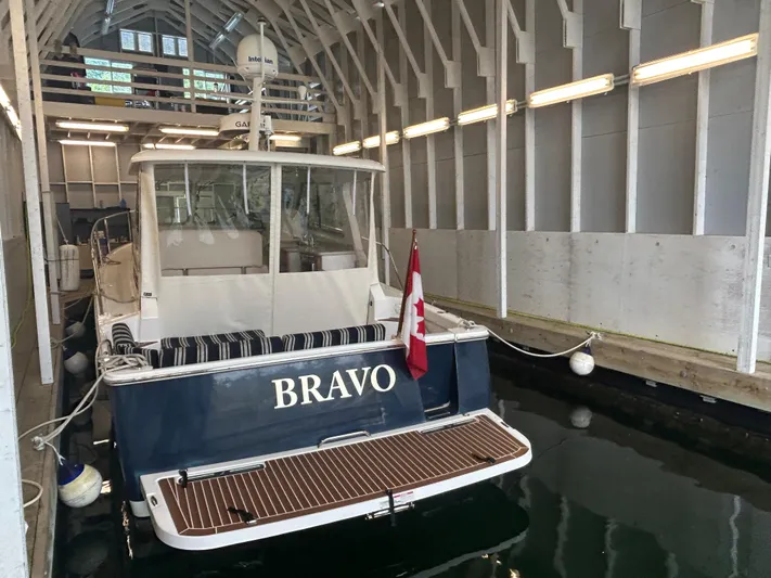  Yacht Photos Pics 2015 Back Cove 34 boat named "Bravo" docked indoors with Canadian flag.