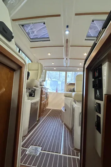 Yacht Photos Pics Interior of a 2015 Back Cove 34 boat, featuring elegant seating and wood flooring.
