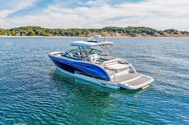  Yacht Photos Pics 2018 Formula 350 FX Crossover Bowrider on serene blue water, scenic coastline backdrop.