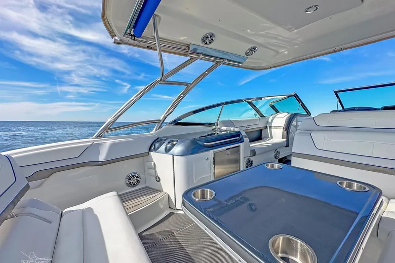  Yacht Photos Pics 2018 Formula 350 FX Crossover Bowrider interior with ocean view, featuring luxurious seating and table.