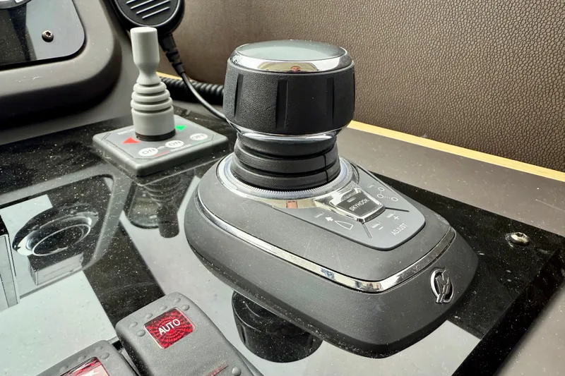 Freiheit Yacht Photos Pics Control panel of a 2020 Prestige 590 yacht with joystick and buttons.