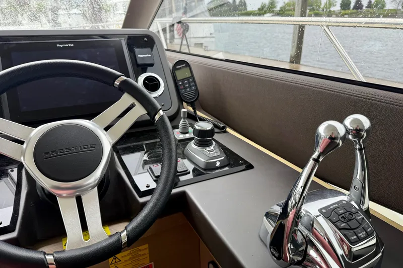 Freiheit Yacht Photos Pics 2020 Prestige 590 yacht helm with steering wheel, controls, and navigation system.