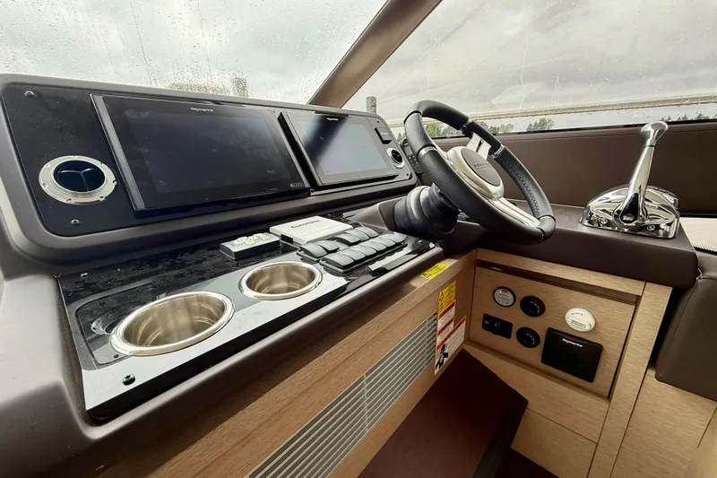 Freiheit Yacht Photos Pics Cockpit of 2020 Prestige 590 yacht with modern navigation controls and steering wheel.