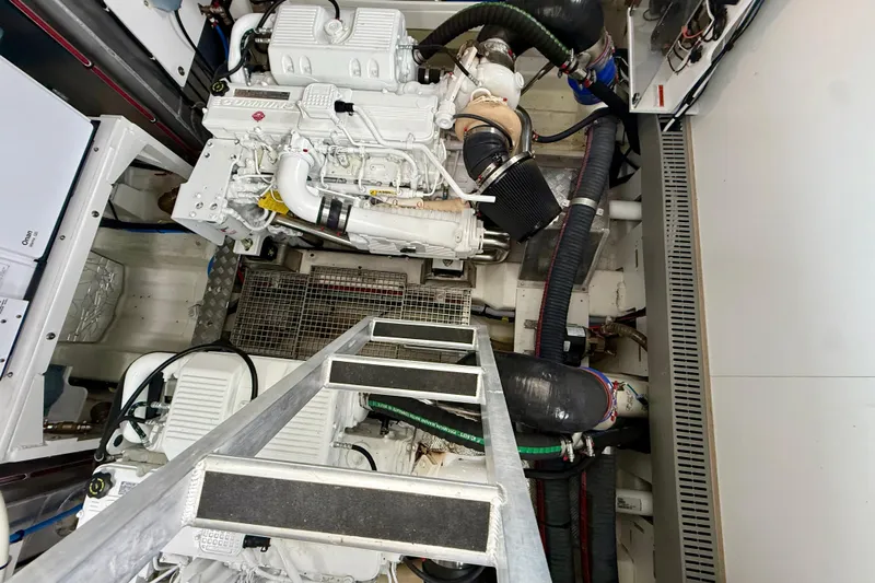 Freiheit Yacht Photos Pics Engine room of a 2020 Prestige 590 yacht, featuring Cummins engines and mechanical components.