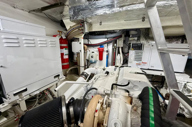 Freiheit Yacht Photos Pics Engine room of a 2020 Prestige 590 yacht, featuring mechanical equipment and fire safety systems.