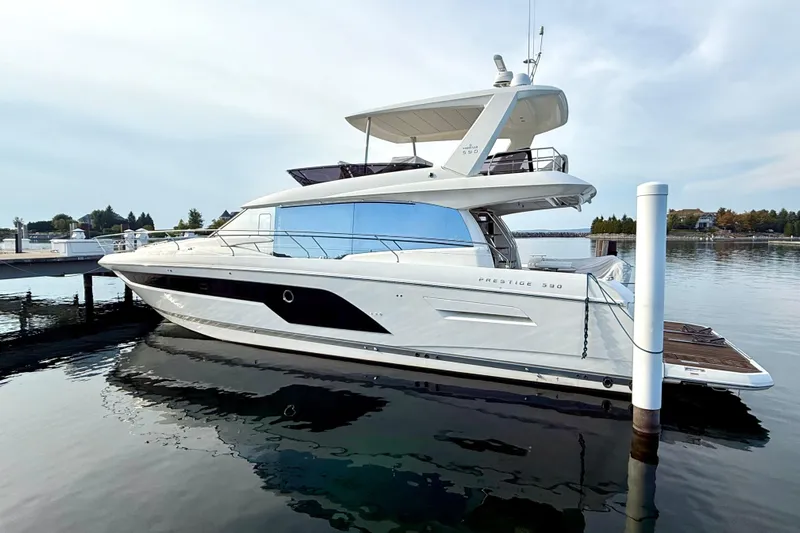 Freiheit Yacht Photos Pics 2020 Prestige 590 yacht docked on calm water, showcasing sleek design and modern features.