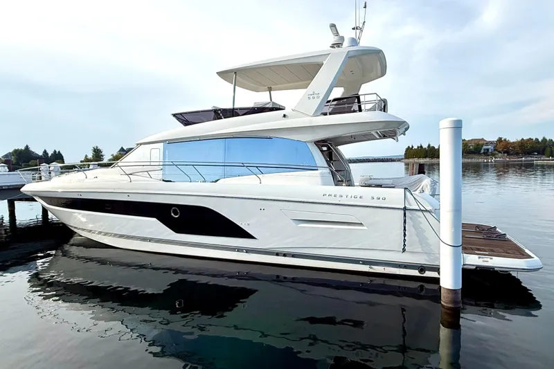 Freiheit Yacht Photos Pics Luxury 2020 Prestige 590 yacht docked on calm water.