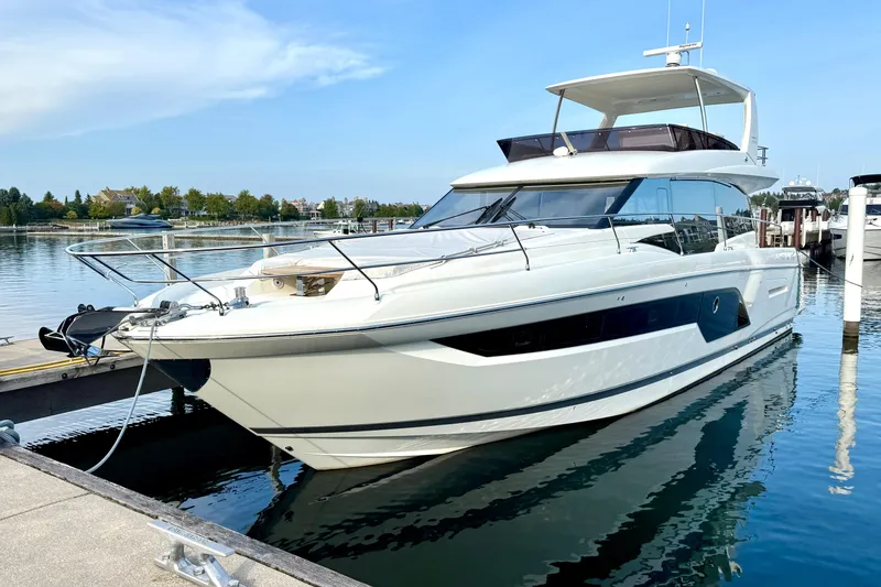 Freiheit Yacht Photos Pics Luxury 2020 Prestige 590 yacht docked in serene marina setting.