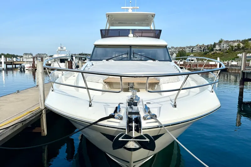 Freiheit Yacht Photos Pics Luxury 2020 Prestige 590 yacht docked in a serene marina setting.