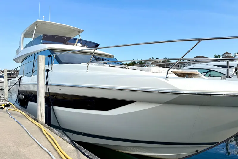 Freiheit Yacht Photos Pics Luxury 2020 Prestige 590 yacht docked at marina under clear blue sky.