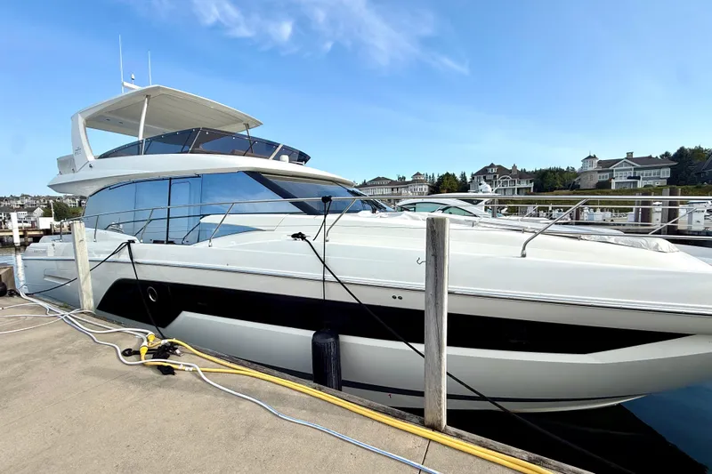 Freiheit Yacht Photos Pics Luxury 2020 Prestige 590 yacht docked at marina under clear blue sky.