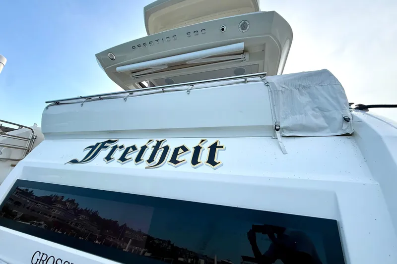 Freiheit Yacht Photos Pics 2020 Prestige 590 yacht with "Freiheit" name, docked at marina.