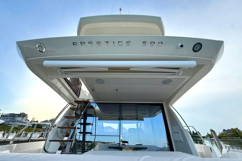 Freiheit Yacht Photos Pics 2020 Prestige 590 yacht, rear view with glass doors and outdoor staircase.