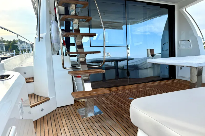 Freiheit Yacht Photos Pics Luxurious 2020 Prestige 590 yacht interior with wooden deck and modern staircase.