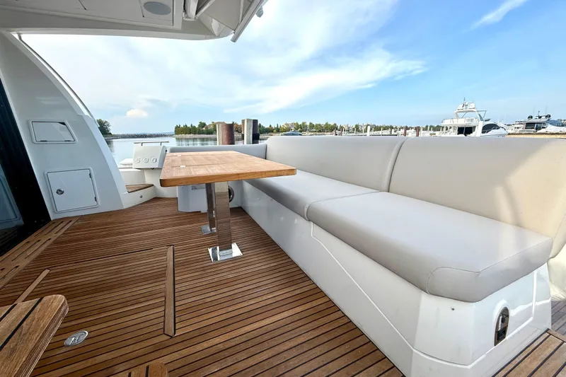 Freiheit Yacht Photos Pics Luxurious 2020 Prestige 590 yacht deck with wooden flooring and comfortable seating.