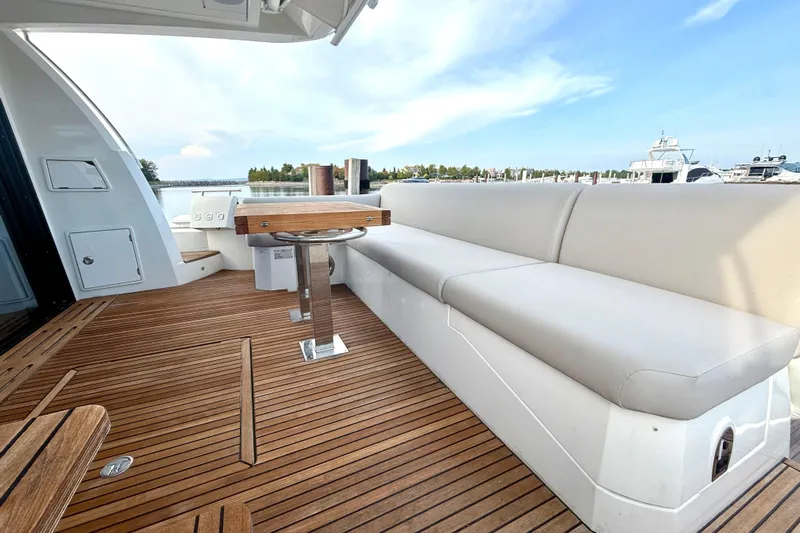Freiheit Yacht Photos Pics Luxurious 2020 Prestige 590 yacht deck with elegant seating and wooden flooring.