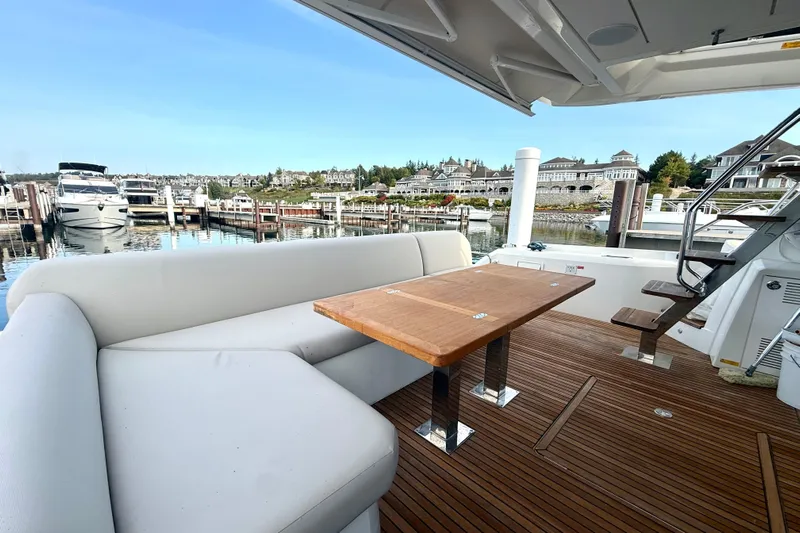 Freiheit Yacht Photos Pics Luxurious 2020 Prestige 590 yacht with elegant deck seating and scenic marina view.