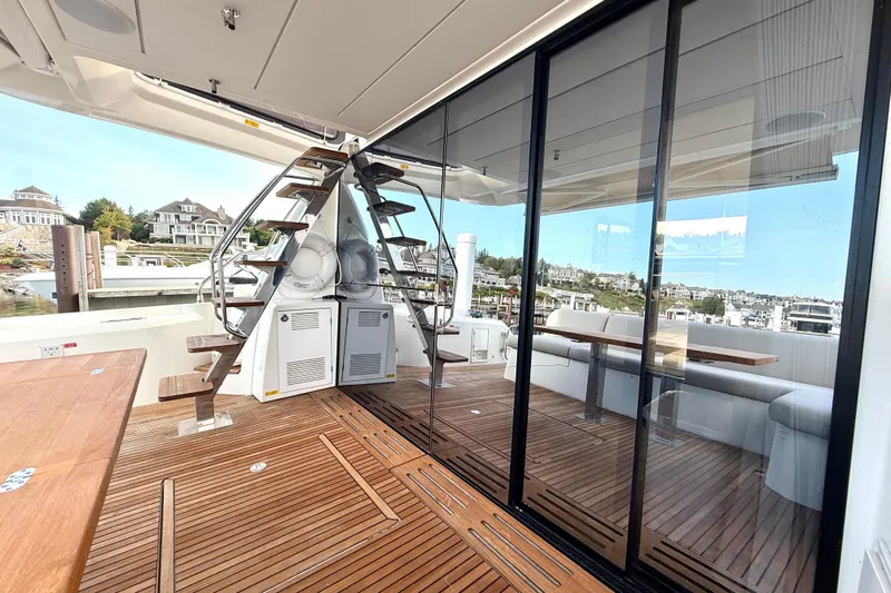 Freiheit Yacht Photos Pics Luxurious 2020 Prestige 590 yacht deck with wooden flooring and glass doors.