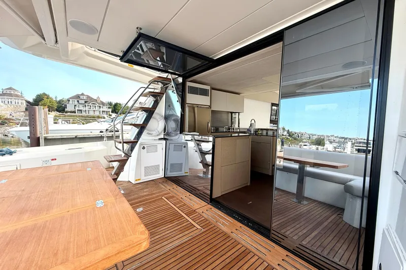 Freiheit Yacht Photos Pics Luxurious 2020 Prestige 590 yacht interior with modern kitchen and outdoor seating area.