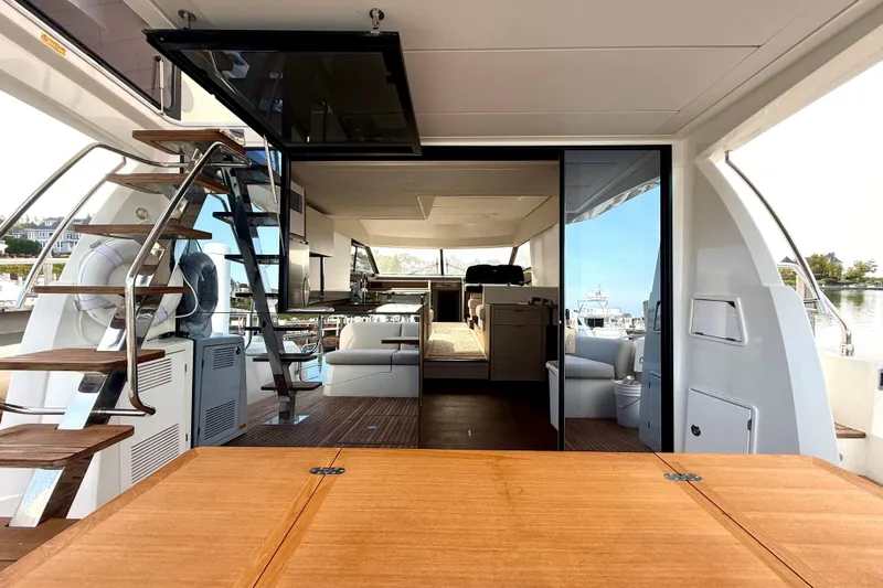Freiheit Yacht Photos Pics Prestige 590 yacht interior, 2020 model, featuring modern design and luxurious seating area.