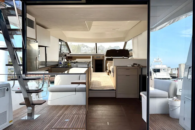 Freiheit Yacht Photos Pics Luxurious 2020 Prestige 590 yacht interior with modern kitchen and seating area.