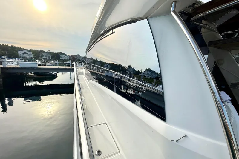 Freiheit Yacht Photos Pics 2020 Prestige 590 yacht docked at marina, reflecting serene waterfront view.