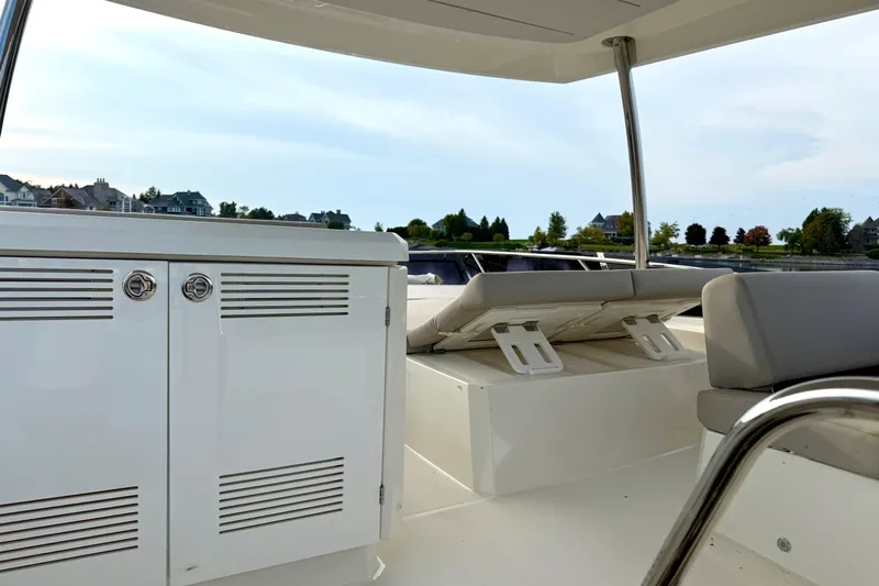 Freiheit Yacht Photos Pics Prestige 590 yacht interior, 2020 model, featuring sleek white cabinetry and comfortable seating.