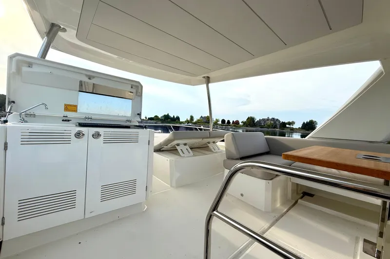Freiheit Yacht Photos Pics Prestige 590 yacht interior, 2020 model, featuring a sleek outdoor kitchen and seating area.