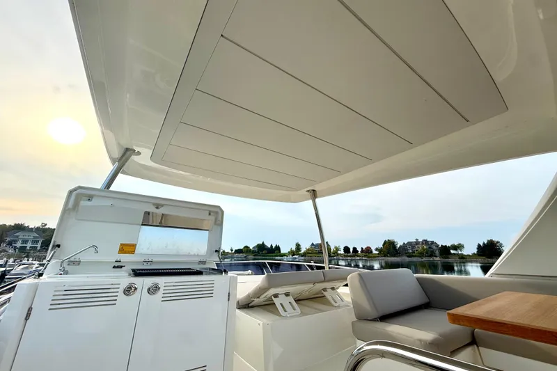 Freiheit Yacht Photos Pics Luxury 2020 Prestige 590 yacht deck with seating and scenic waterfront view.