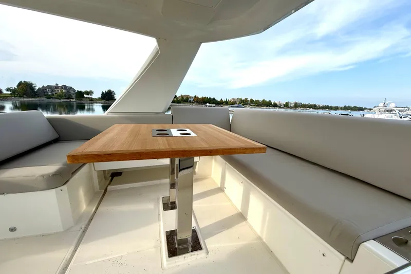 Freiheit Yacht Photos Pics Luxurious seating area on a 2020 Prestige 590 yacht with scenic waterfront view.