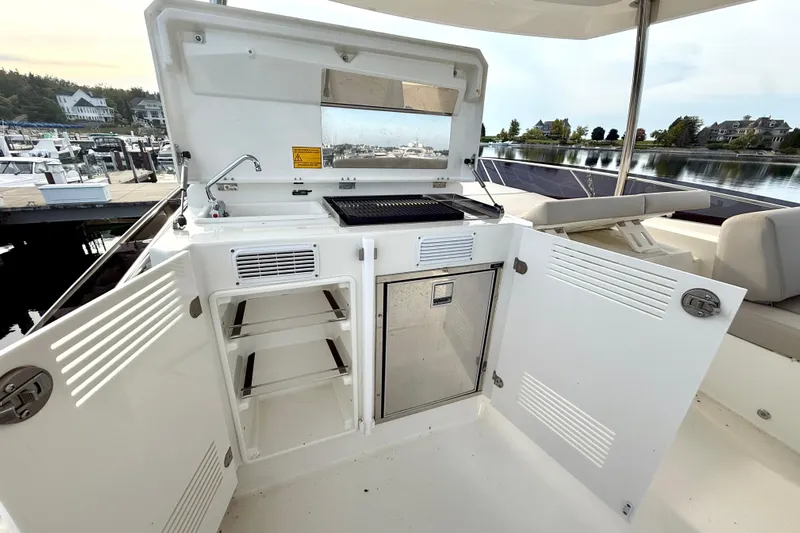 Freiheit Yacht Photos Pics Prestige 590 yacht outdoor kitchen with grill and storage, docked at marina, 2020 model.