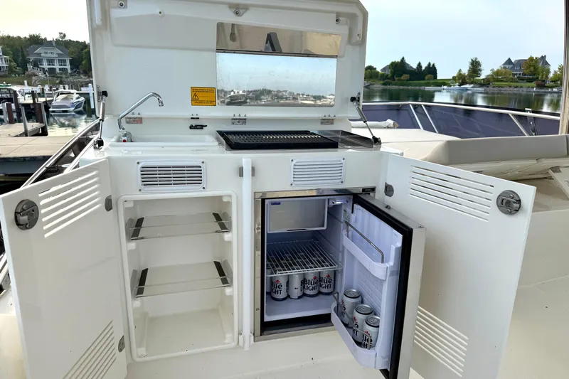 Freiheit Yacht Photos Pics Prestige 590 yacht 2020 model with open fridge and storage on deck.