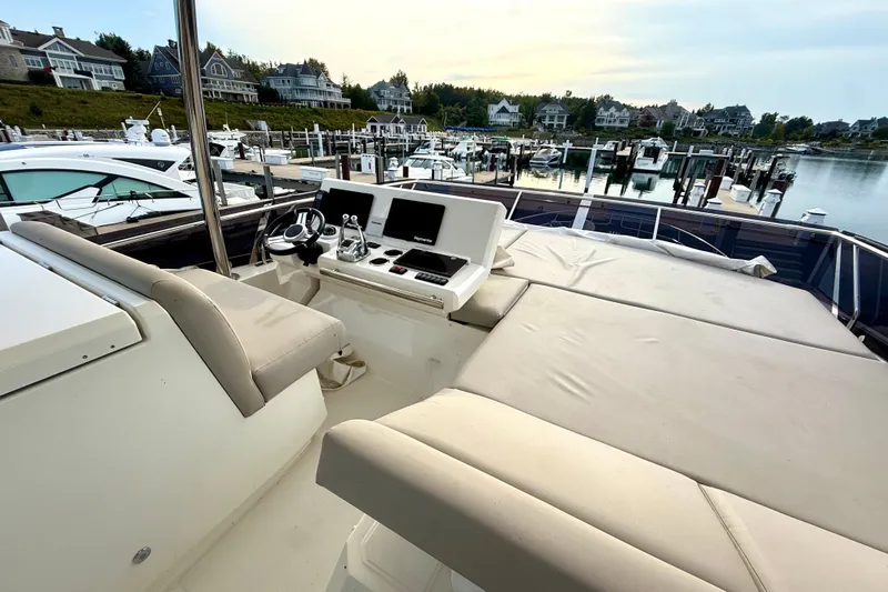 Freiheit Yacht Photos Pics Luxurious 2020 Prestige 590 yacht interior with helm, docked in scenic marina.