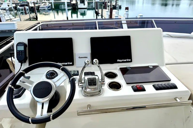 Freiheit Yacht Photos Pics Helm of 2020 Prestige 590 yacht with navigation controls and Raymarine displays.