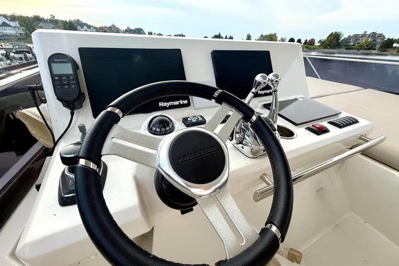 Freiheit Yacht Photos Pics Helm of 2020 Prestige 590 yacht with Raymarine navigation system and controls.