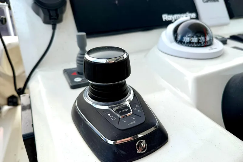 Freiheit Yacht Photos Pics Control panel of a 2020 Prestige 590 yacht with joystick and compass.