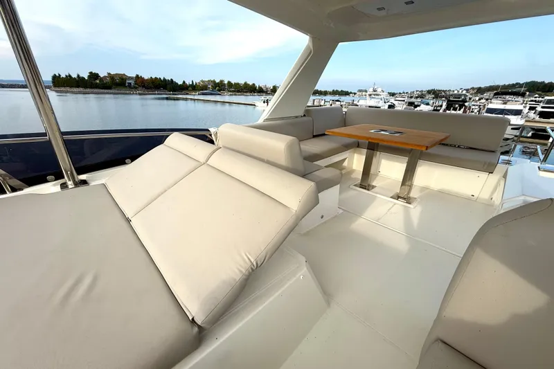 Freiheit Yacht Photos Pics Luxurious 2020 Prestige 590 yacht interior with comfortable seating and scenic marina view.