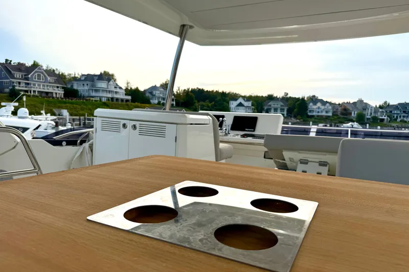 Freiheit Yacht Photos Pics Luxury yacht interior of 2020 Prestige 590 with marina view and elegant wooden table.