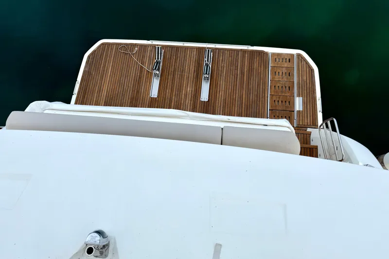 Freiheit Yacht Photos Pics Prestige 590 yacht's teak deck, 2020 model, viewed from above against green water.