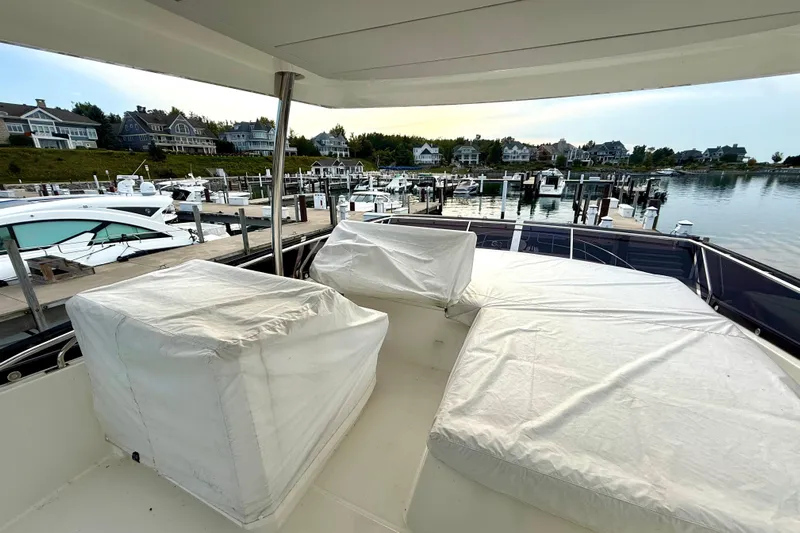 Freiheit Yacht Photos Pics Prestige 590 yacht (2020) docked at marina with covered seating area.