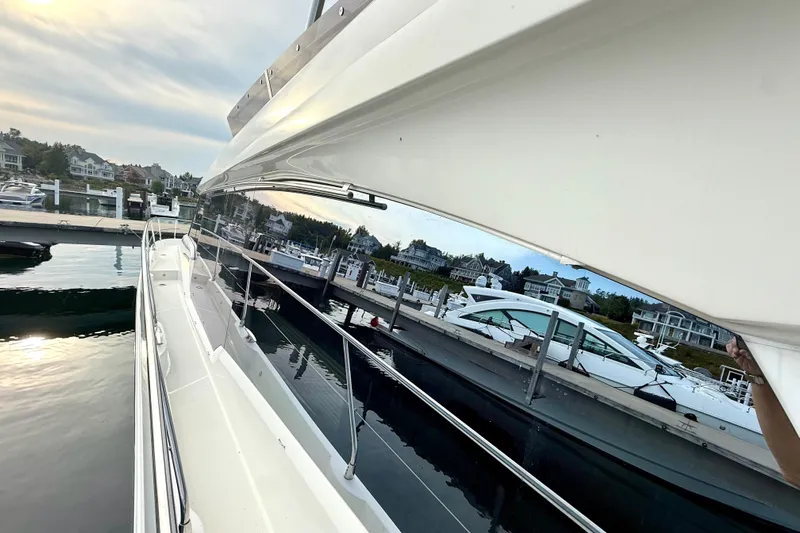 Freiheit Yacht Photos Pics 2020 Prestige 590 yacht docked at marina, reflecting serene waterfront view.