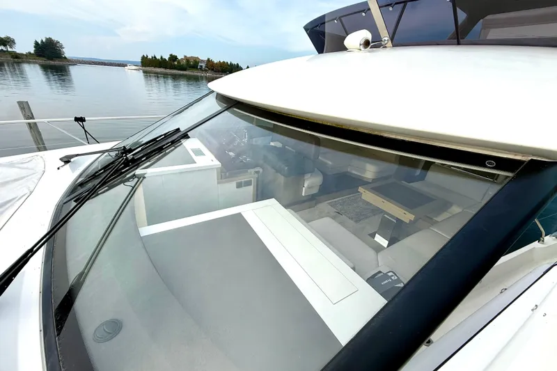 Freiheit Yacht Photos Pics 2020 Prestige 590 yacht with sleek design, docked by serene waters.