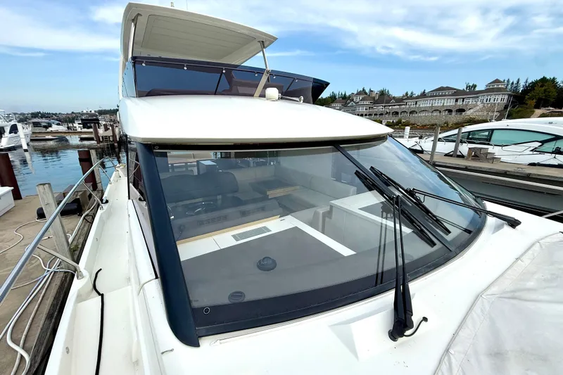 Freiheit Yacht Photos Pics 2020 Prestige 590 yacht docked at marina with scenic waterfront view.