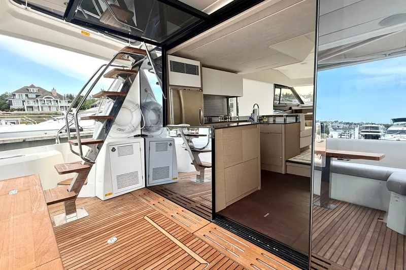 Freiheit Yacht Photos Pics Luxurious 2020 Prestige 590 yacht interior with modern kitchen and wooden deck.