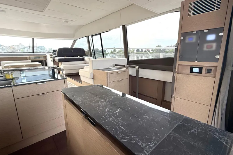 Freiheit Yacht Photos Pics Luxurious interior of 2020 Prestige 590 yacht with modern furnishings and panoramic windows.