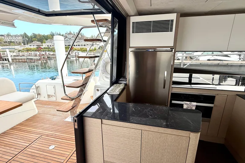 Freiheit Yacht Photos Pics Luxurious 2020 Prestige 590 yacht interior with modern kitchen and outdoor deck view.