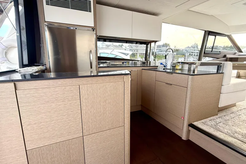 Freiheit Yacht Photos Pics Luxurious kitchen interior of 2020 Prestige 590 yacht with modern appliances and sleek design.
