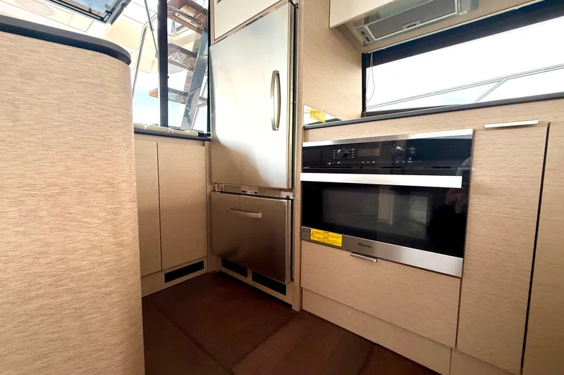 Freiheit Yacht Photos Pics Modern kitchen interior on a 2020 Prestige 590 yacht, featuring sleek appliances and cabinetry.